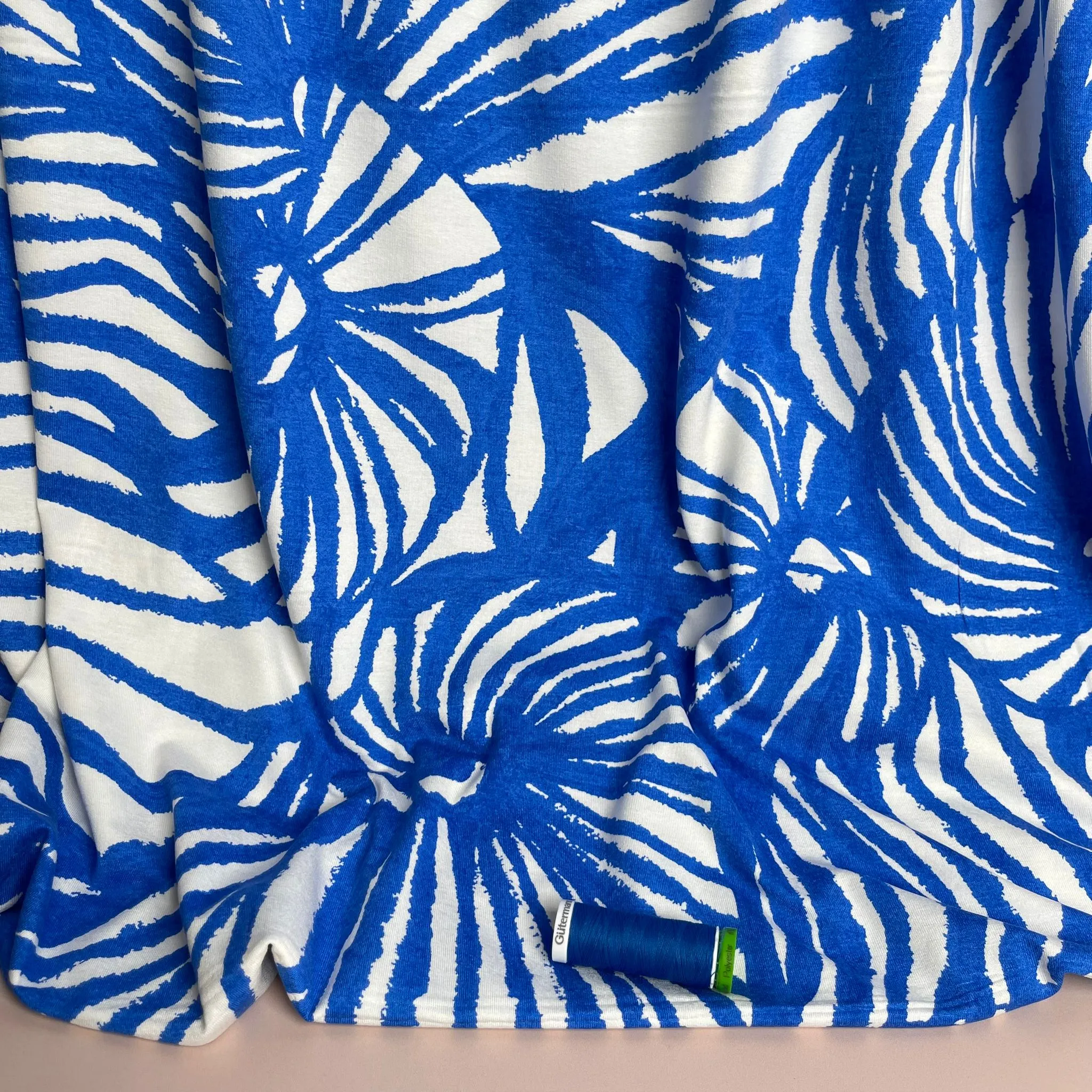 Ex-Designer Deadstock Ammonite Fossils on Blue Viscose Jersey Fabric