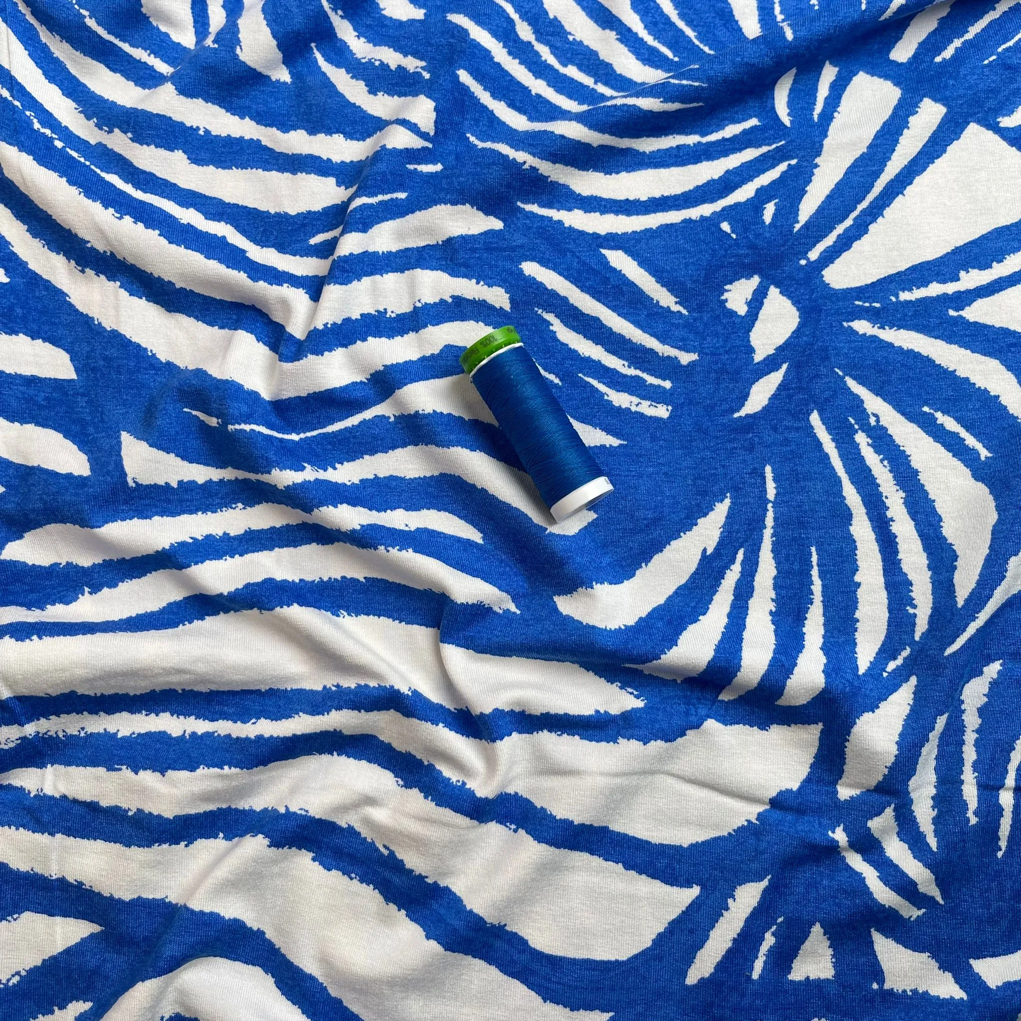 Ex-Designer Deadstock Ammonite Fossils on Blue Viscose Jersey Fabric