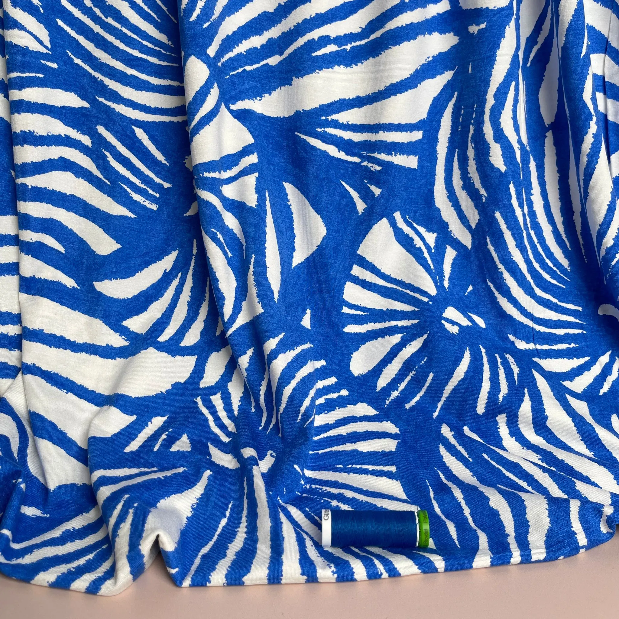 Ex-Designer Deadstock Ammonite Fossils on Blue Viscose Jersey Fabric