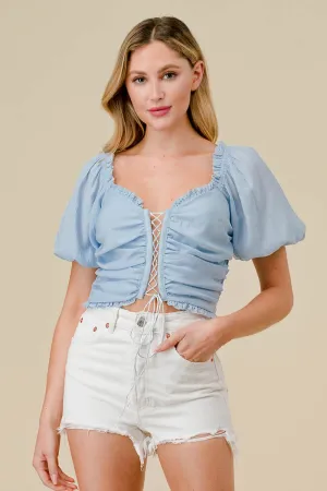  ruffled lace trim drawstring cropped top is made from a durable poly woven material. The textured fabric adds interest to any outfit while the drawstring and lace details add a touch of femininity. Perfect for a breezy